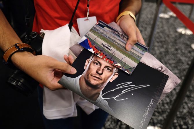 <strong>Autograph seeker: </strong>Dyann holds a poster signed poster by Alfa Romeo driver Kimi Raikkonen.