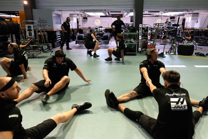 <strong>Pit prep: </strong>F1 engineers from the Haas Formula One team get ready to practice a quick tire change.