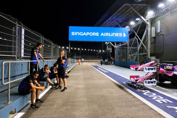 <strong>Inside the pit: </strong>Engineers take a break along the pit lane.