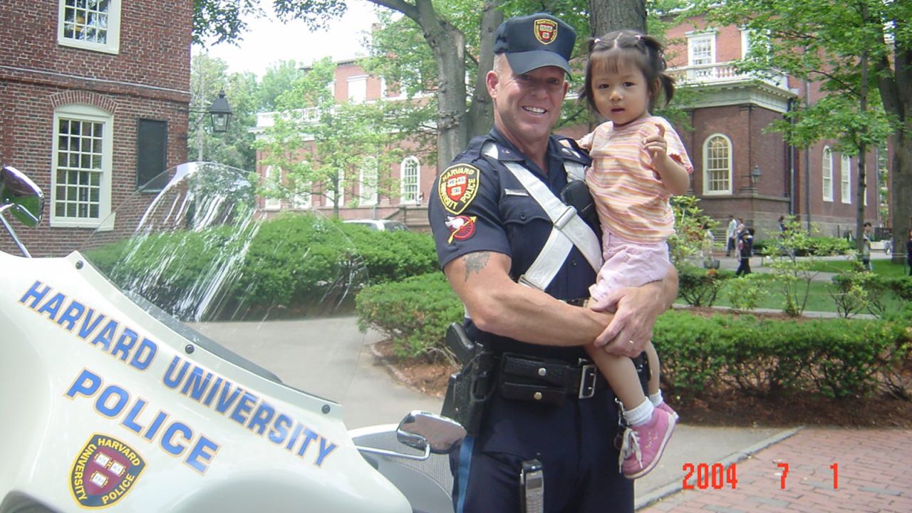 Crystal Wang was 3 years old when her father snapped a picture of her in the arms of Marren.