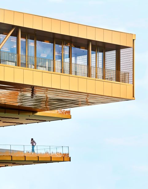 The overhanging floors were designed to evoke the feeling of a galloping race horse with colors to match the autumnal hues of the Bois de Boulogne.