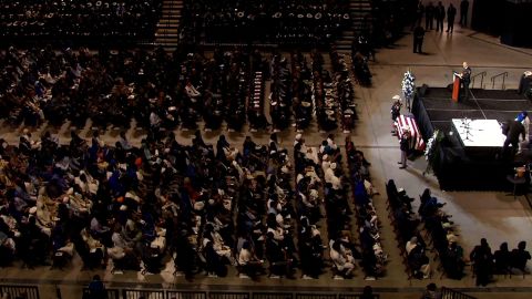 Dhaliwal's casket, flanked by two sheriff's deputies, rests in front of a stage at his funeral Wednesday.