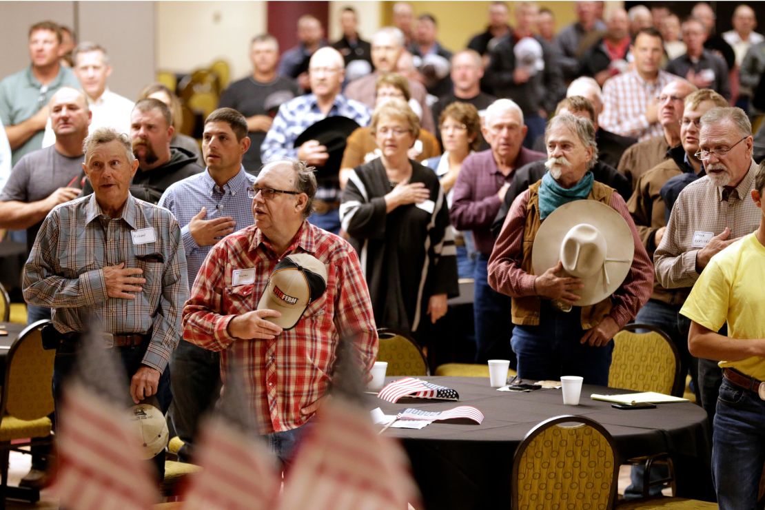 The Pledge of Allegiance is recited in Omaha, Nebraska, at the start of a meeting to urge President Trump to ensure fair prices for cattle farmers and ranchers.