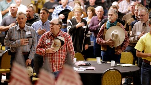 The Pledge of Allegiance is recited in Omaha, Nebraska, at the start of a meeting to urge President Trump to ensure fair prices for cattle farmers and ranchers.