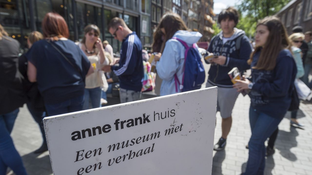 Tourists line up outside the Anne Frank House in Amsterdam