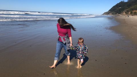 Downing walks on a beach in Oregon with her 4-year-old son.