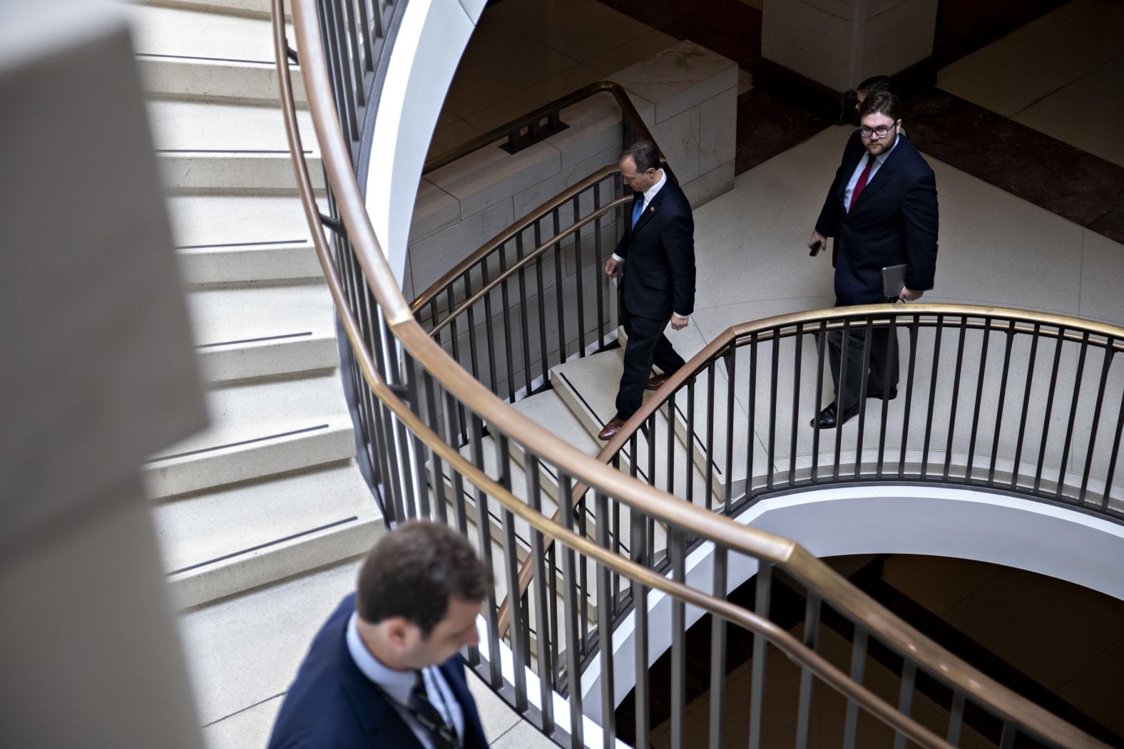 Schiff, center, walks down the steps of the House Visitor Center after a <a href="index.php?page=&url=https%3A%2F%2Fwww.cnn.com%2F2019%2F10%2F02%2Fpolitics%2Fwhite-house-subpoena-threat%2Findex.html" target="_blank">news conference</a> on October 2. Schiff told reporters that any efforts to block information from congressional committees could be viewed as corroborating the allegations. <a href="index.php?page=&url=https%3A%2F%2Fwww.cnn.com%2Fpolitics%2Flive-news%2Ftrump-impeachment-inquiry-10-02-2019%2Fh_0205b4b28ae8b5656689d6b6d7858537" target="_blank">He also reiterated</a> that the whistleblower has the right to remain anonymous, saying Congress would do "everything in our power" to make sure that the person is protected.