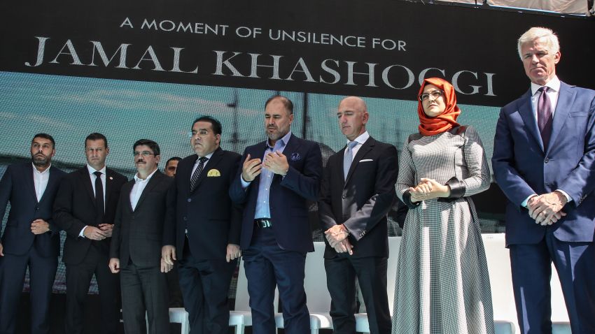 ISTANBUL, TURKEY - OCTOBER 02: Hatice Cengiz (2nd R), fiancee of murdered Saudi journalist Jamal Kashoggi, and CEO of Amazon and Washington Post owner Jeff Bezos (3rd R), accompanied by his colleagues and friends, pause for a minute of silence during a ceremony near the Saudi Arabia consulate in Istanbul on October 02, 2019 in Istanbul, Turkey.  Jamal Khashoggi, the Saudi Arabian dissident and columnist for the Washington Post, was killed on 2nd October 2018 after entering the Saudi Consulate in Istanbul to finalize papers for his marriage, sparking a weeks long investigation and creating diplomatic tension between, Turkey, the U.S and Saudi Arabia. His body is still yet to be recovered. (Photo by Osman Orsal/Getty Images)