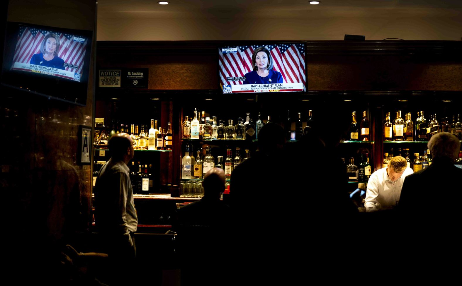 Two men inside New York's Trump Tower watch Pelosi on television on September 24. "Today, I am announcing the House of Representatives moving forward with an official impeachment inquiry," Pelosi said <a href="https://www.cnn.com/2019/09/24/politics/democrats-impeachment-strategy/index.html" target="_blank">in a brief speech in the Capitol,</a> adding, "The President must be held accountable. No one is above the law."