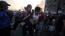 An Iraqi protester carries a wounded comrade during a demonstration against state corruption, failing public services and unemployment at Tayaran square in Baghdad on October 2, 2019. - Iraq's president and the United Nations urged security forces to show restraint after two protesters were killed in clashes with police that other top officials blamed on "infiltrators." (Photo by AHMAD AL-RUBAYE / AFP) (Photo by AHMAD AL-RUBAYE/AFP via Getty Images)