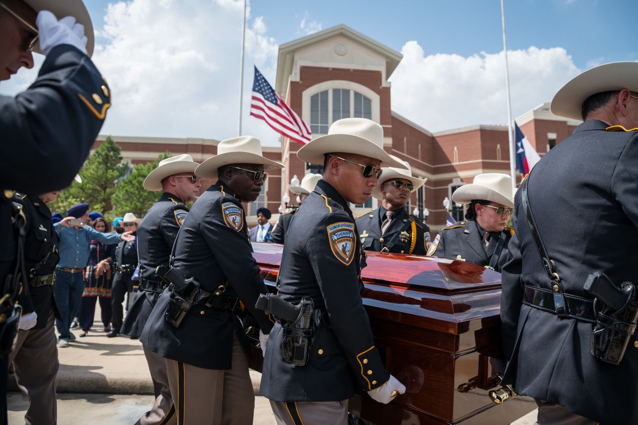 The casket of slain Harris County sheriff's Deputy Sandeep Dhaliwal is carried toward a waiting hearse following funeral services at the Berry Center of Northwest Houston in Cypress, Texas, on Wednesday, October 2. 