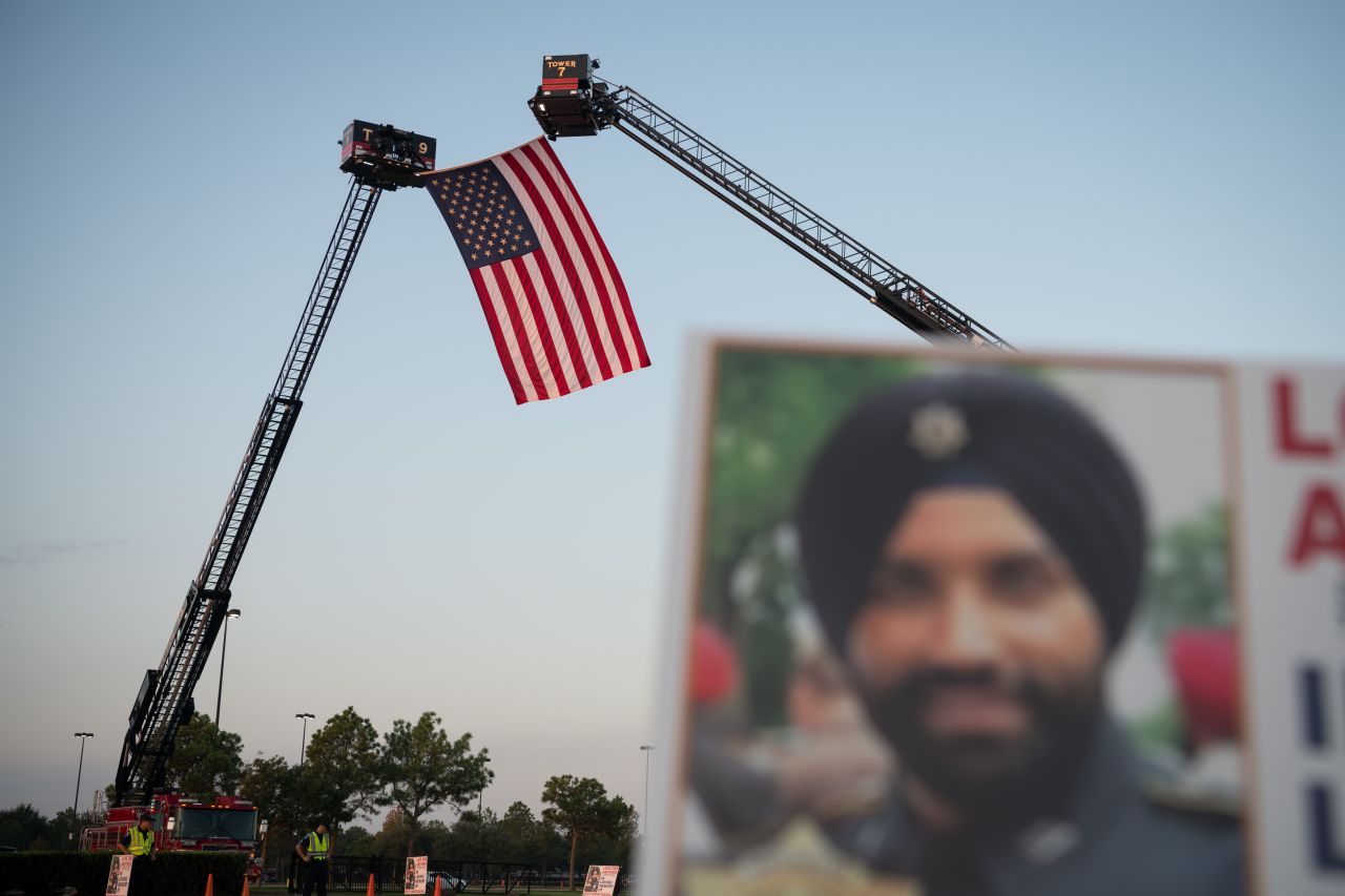 An American flag honoring Dhaliwal is is suspended by two firetrucks near the Berry Center. 