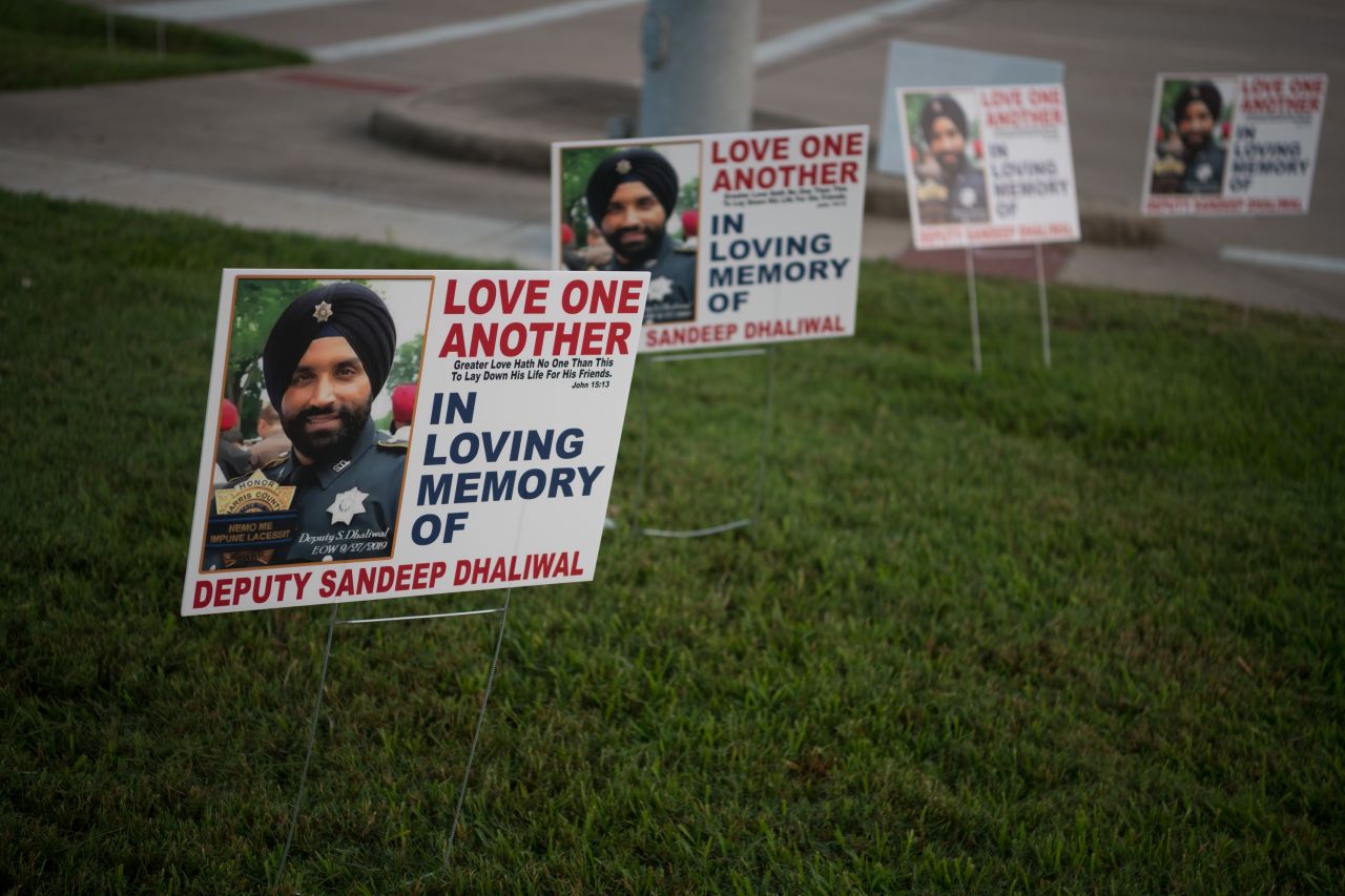 Signs honoring Dhaliwal are seen near the Berry Center before the funeral services.