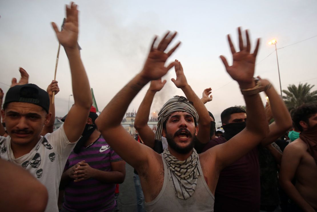 Iraqi protesters chant during a demonstration against state corruption, failing public services and unemployment in Baghdad on October 2, 2019.