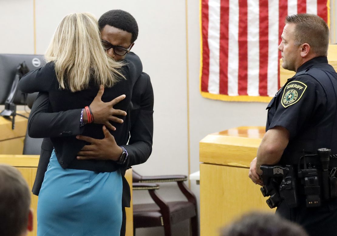 Botham Jean's younger brother Brandt Jean hugs convicted murderer and former Dallas Police Officer Amber Guyger.