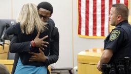 Botham Jean's younger brother Brandt Jean hugs convicted murderer and former Dallas Police Officer Amber Guyger after delivering his impact statement to her after she was sentenced to 10 years in jail, Wednesday, Oct. 2, 2019, in Dallas. Guyger shot and killed Botham Jean, an unarmed 26-year-old neighbor in his own apartment last year. She told police she thought his apartment was her own and that he was an intruder. (Tom Fox/Dallas Morning News via AP, Pool)