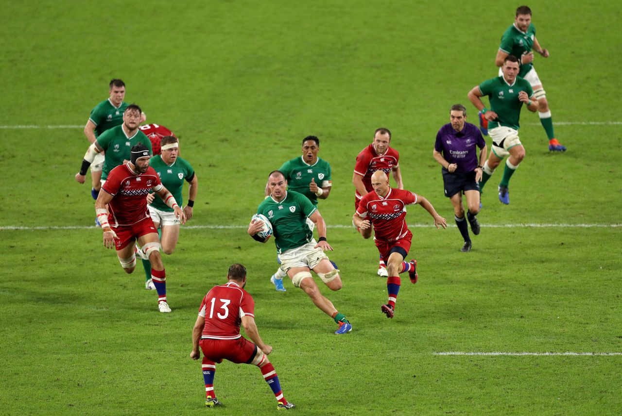 Rhys Ruddock of Ireland runs with the ball towards Igor Galinovskiy of Russia during the match in Kobe.