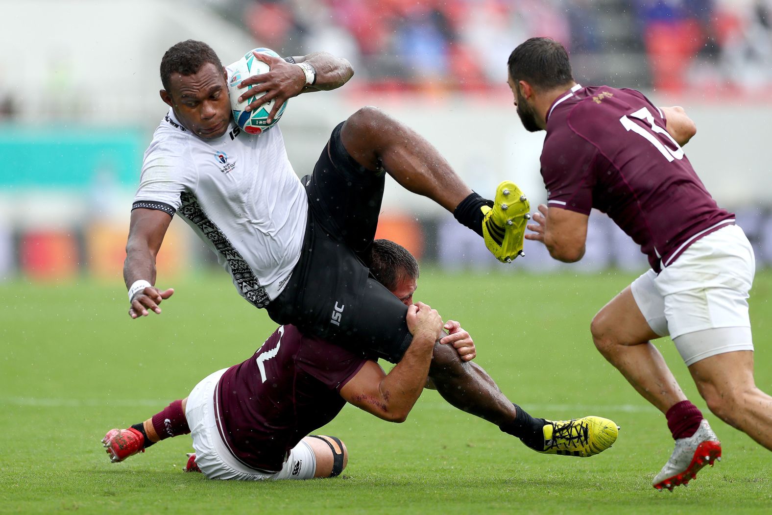 Fiji's Leone Nakarawa is tackled by Merab Sharikadze of Georgia.