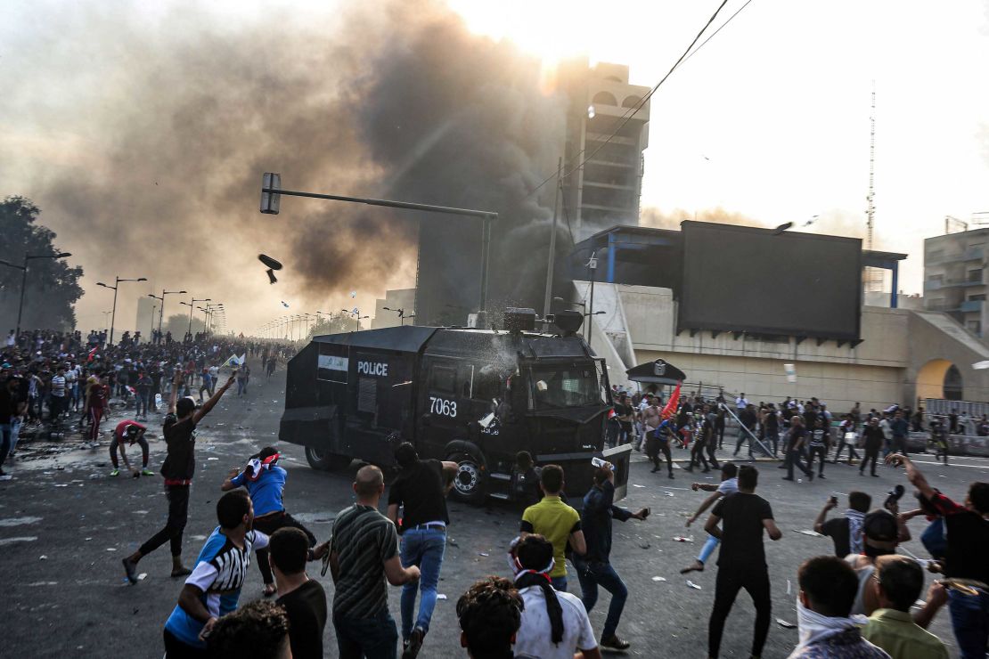 Protesters clash with an Iraqi riot police vehicle during a demonstration in Baghdad on Monday.