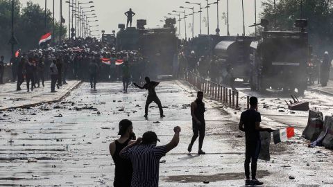 Protesters clash with Iraqi riot police vehicles in Baghdad's Tahrir Square in October 2019. 
