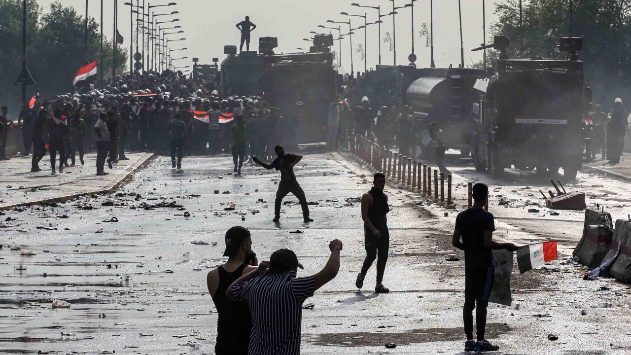 Protesters clash with Iraqi riot police vehicles in Baghdad's Tahrir Square in October 2019.