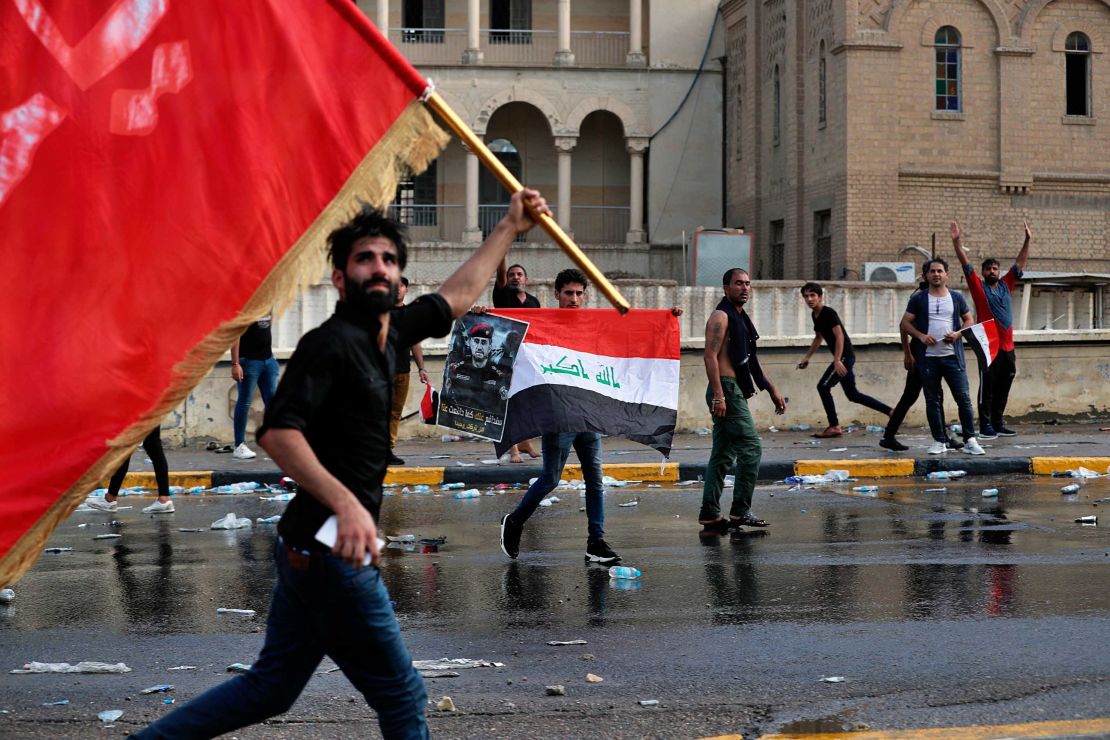 Protestors wave flags during a protest in Tahrir Square on October 1.