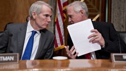 Senator Ron Johnson, a Republican from Wisconsin and chairman of the Senate Finance Committee, right, talks to Senator Rob Portman, a Republican from Ohio, during a hearing on migration at the United States southern border in Washington, DC on July 30, 2019. 