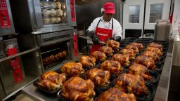 Dios Ruiz, a service deli worker for Costco Wholesale Corp., places cooked rotisserie chickens in containers at a store in San Francisco, California, U.S., on Tuesday, Dec. 6, 2011. Costco Wholesale Corp., a wholesale membership warehouse company, is scheduled to release earnings on Dec. 8. Photographer: David Paul Morris/Bloomberg via Getty Images 