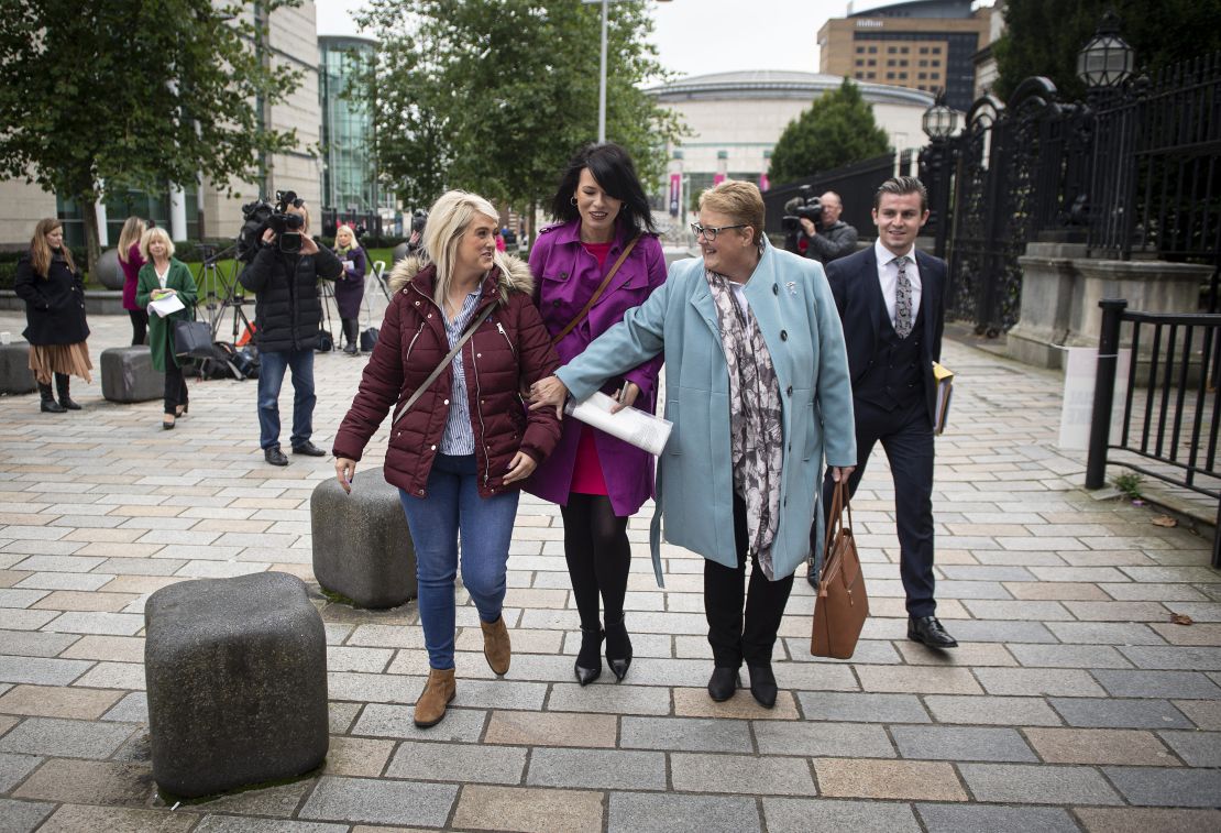 Sarah Ewart (L) alongside her mother Jane Christie (R) and Grainne Teggart (C) of Amnesty International leave Belfast High Court.