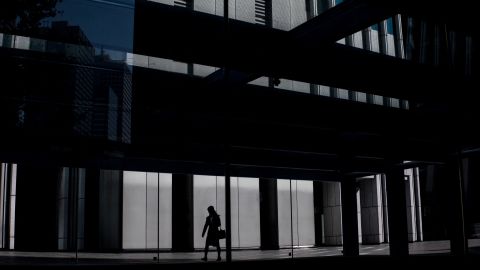 A woman leaves an office building in Tokyo, Japan (file photo).