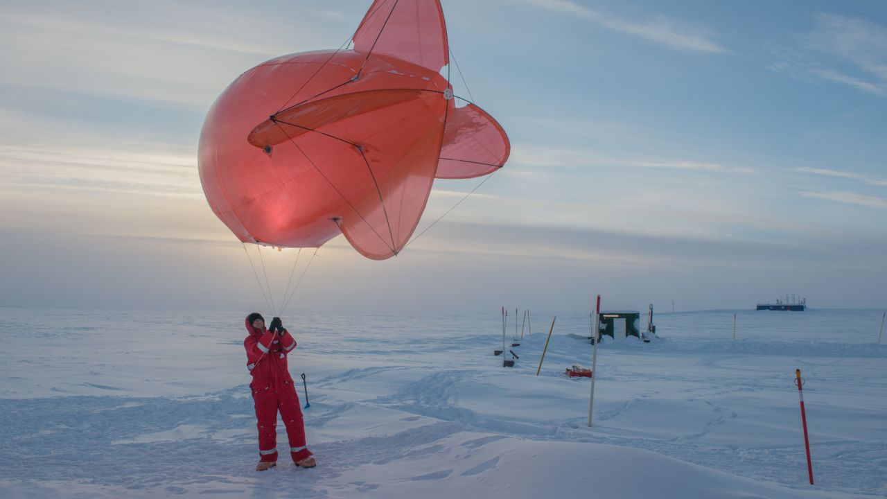 A Leibniz Institute for Tropospheric Research team member operating a helium-filled balloon in Greenland, 2018. Horvath followed the years of preparations which led to the MOSAiC expedition finally departing in September 2019.