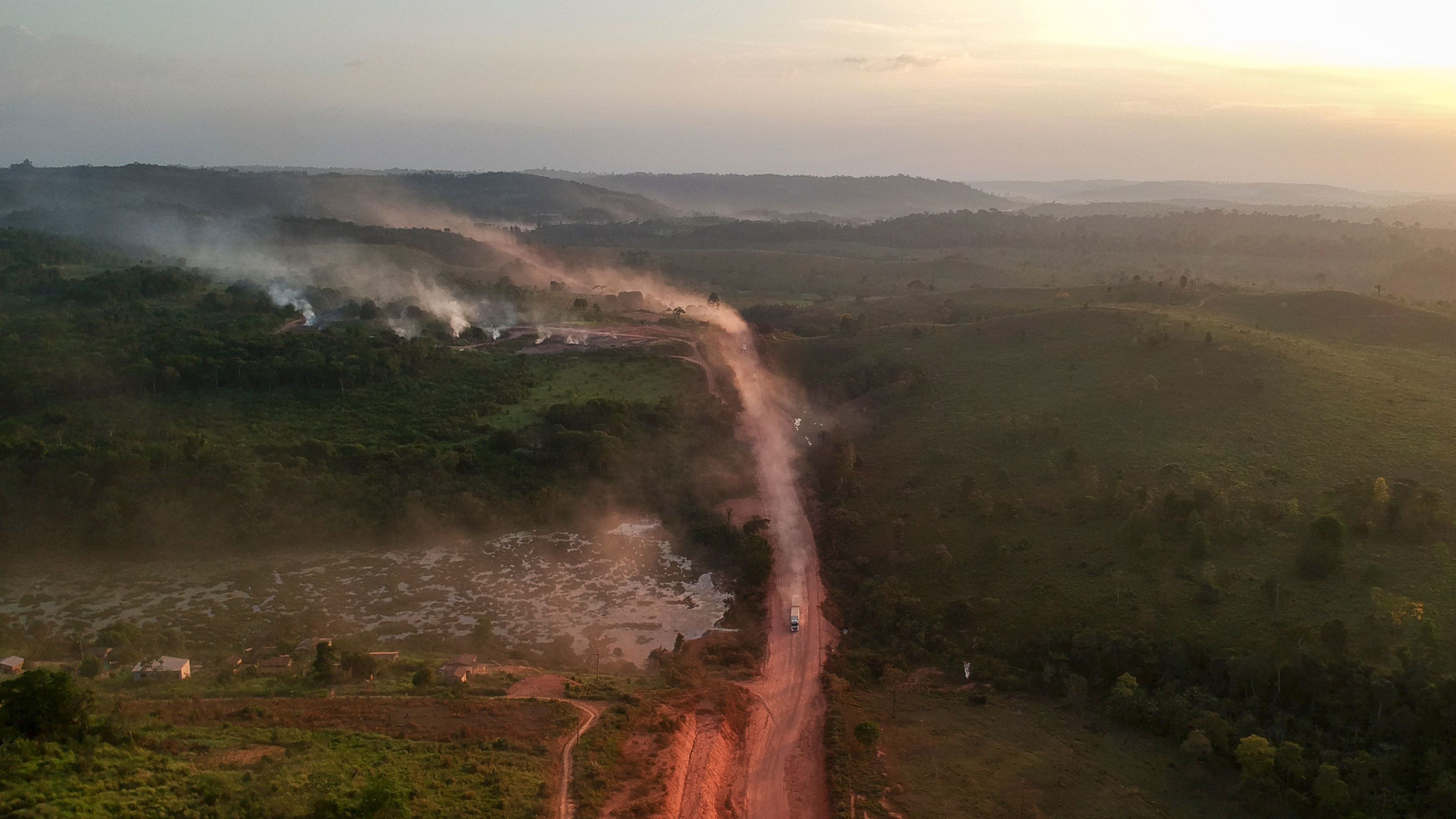 TOPSHOT - In this aerial view the red dust of the BR230 highway, known as "Transamazonica", mixes with fires at sunset in the agriculture town of Ruropolis, Para state, northen Brazil, on September 6, 2019. - Presidents and ministers from seven Amazon countries met in Colombia on Friday to agree on  measures to protect the world's biggest rainforest, under threat from wildfires and rampant deforestation. The summit took place in the wake of an international outcry over months of raging fires that have devastated swaths of the Amazon in Brazil and Bolivia. (Photo by Johannes MYBURGH / AFP)        (Photo credit should read JOHANNES MYBURGH/AFP/Getty Images)