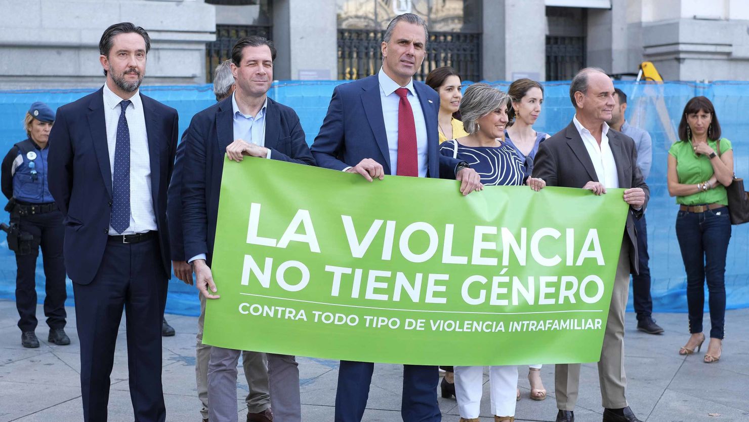 Vox spokesman Javier Ortega Smith (center) takes part in a minute's silence for a victim of gender-based violence with a banner that reads: "Violence has no gender. Against all types of domestic violence."