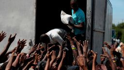 People in need of food call out for a sack of rice during a federal government distribution of food and school supplies to some residents of Cite Soleil, in Port-au-Prince, Haiti, Thursday, Oct. 3, 2019. The daily struggles of Haitians have only become more acute as recent anti-government protests and roadblocks force the closure of businesses, sometimes permanently, as people lose jobs and dwindling incomes fall behind a spike in prices. (AP Photo/Rebecca Blackwell)