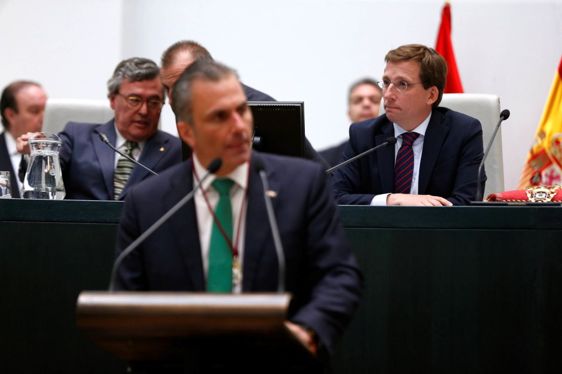 Vox party spokesman Javier Ortega Smith (front) speaks as Madrid Mayor Jose Luis Martinez Almeida (right) listens in during a plenary session of the Town Hall's constitution.