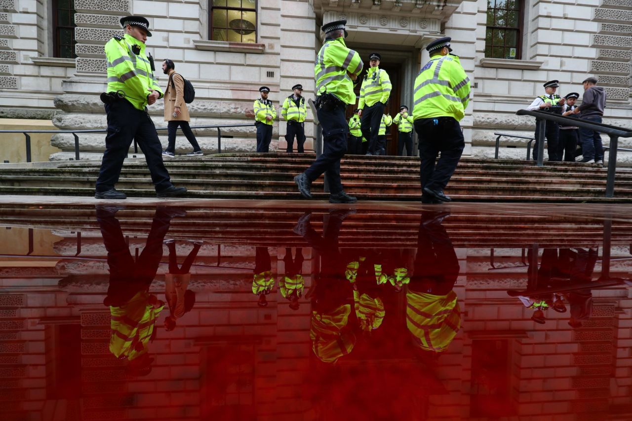 Police officers walk outside the Treasury building in London, where an environmental activist group <a href="https://www.cnn.com/2019/10/03/uk/uk-finance-ministry-extinction-rebellion-gbr-intl-scli/index.html" target="_blank">sprayed 1,800 liters of fake blood</a> on Thursday, October 3.