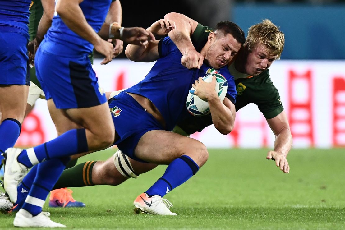 Italy's Luca Morisi is tackled by Pieter-Steph du Toit in the Pool B encounter.