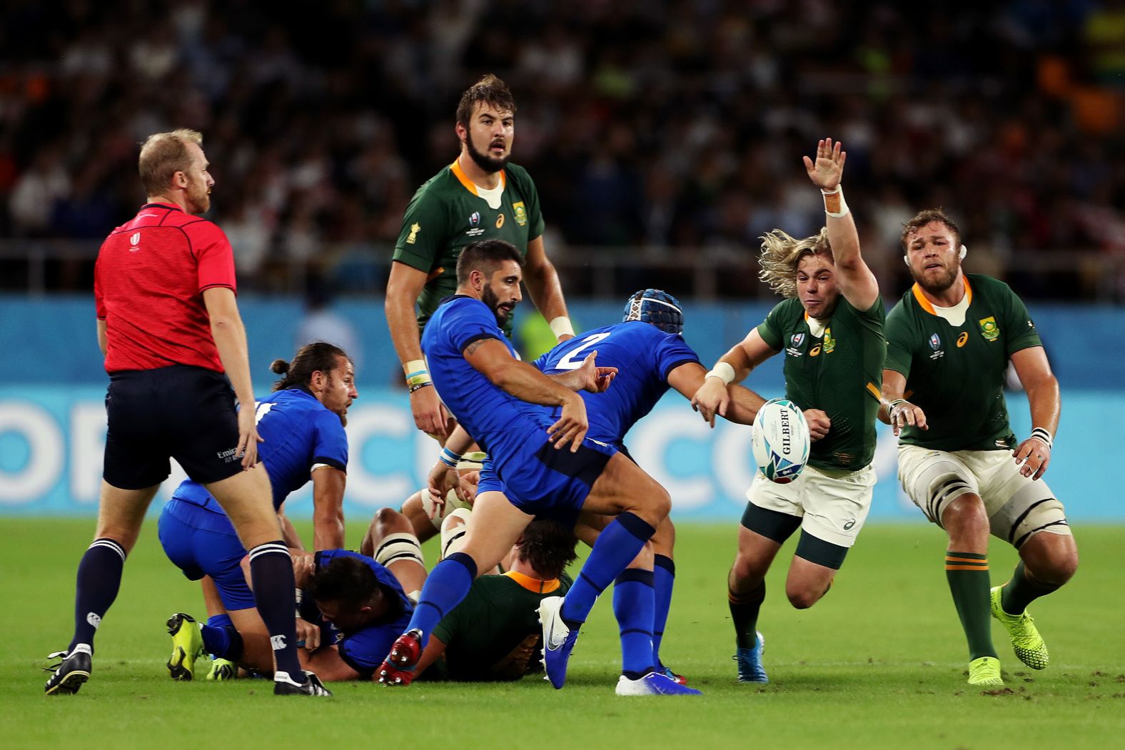 Tito Tebaldi of Italy kicks under pressure from Faf De Klerk of South Africa.