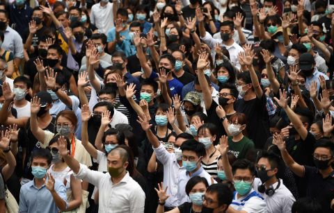 Pro-democracy demonstrators hold up their hands to symbolize their five demands during a rally on October 4.