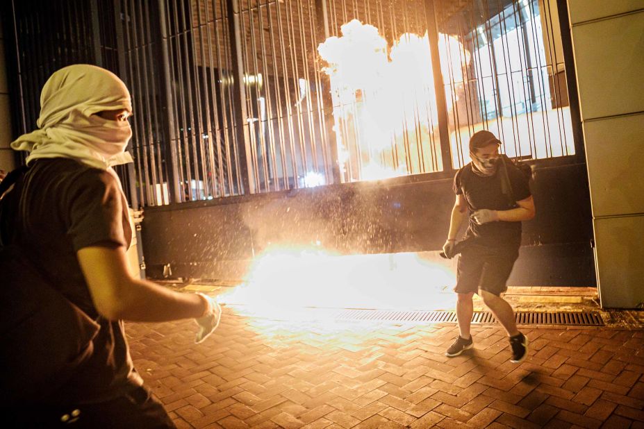Protesters throw petrol bombs at the gate to the Tsuen Wan police station on Wednesday, October 2.