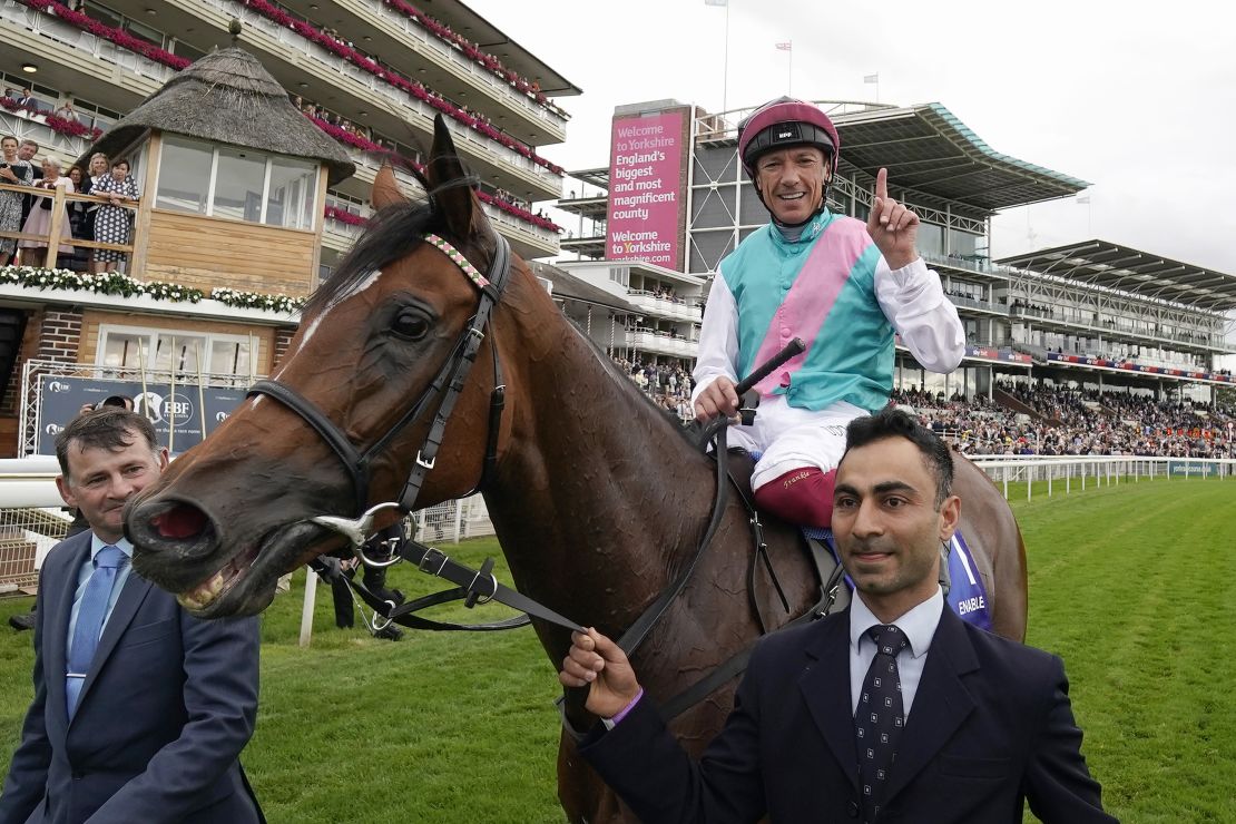 Imran Shawani holds Enable as Frankie Dettori celebrates after winning the Yorkshire Oaks in August. 