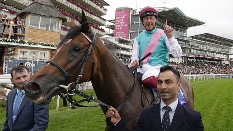 Imran Shawani holds Enable as Frankie Dettori celebrates after winning the Yorkshire Oaks in August. 