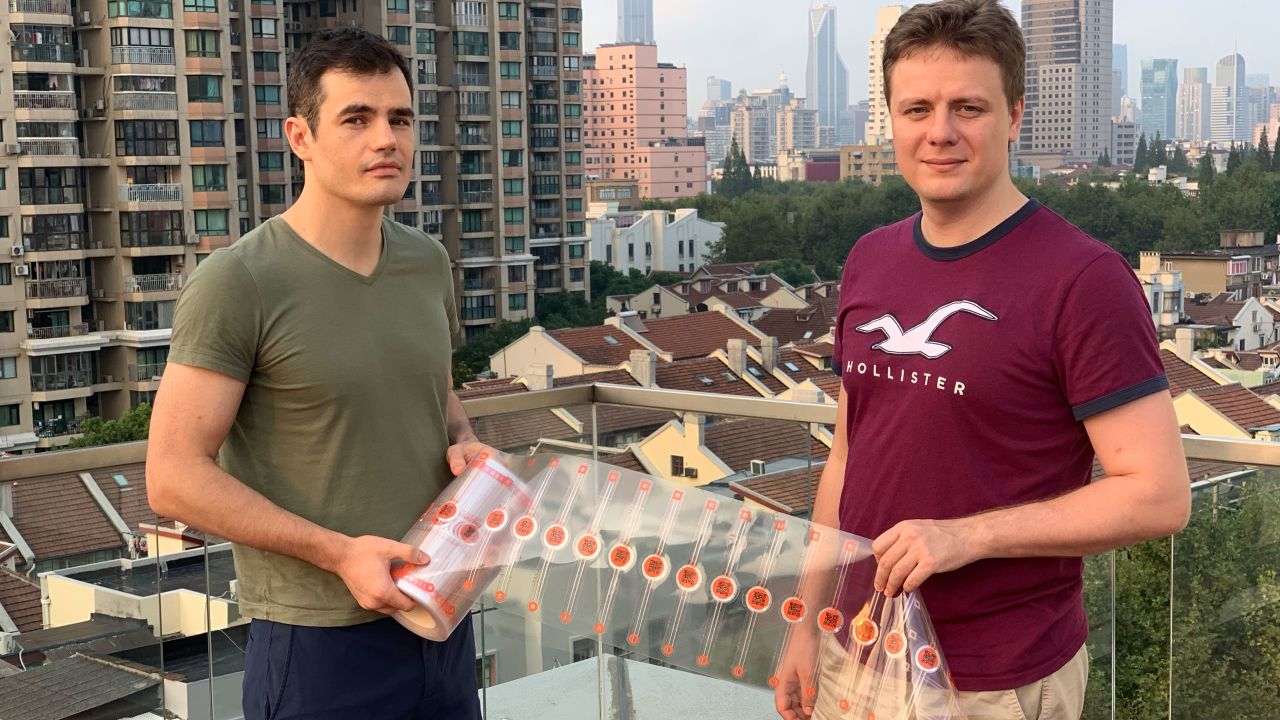 Techrock founders Yaroslav Belinskiy and Alex Busarov display their NFC labels.