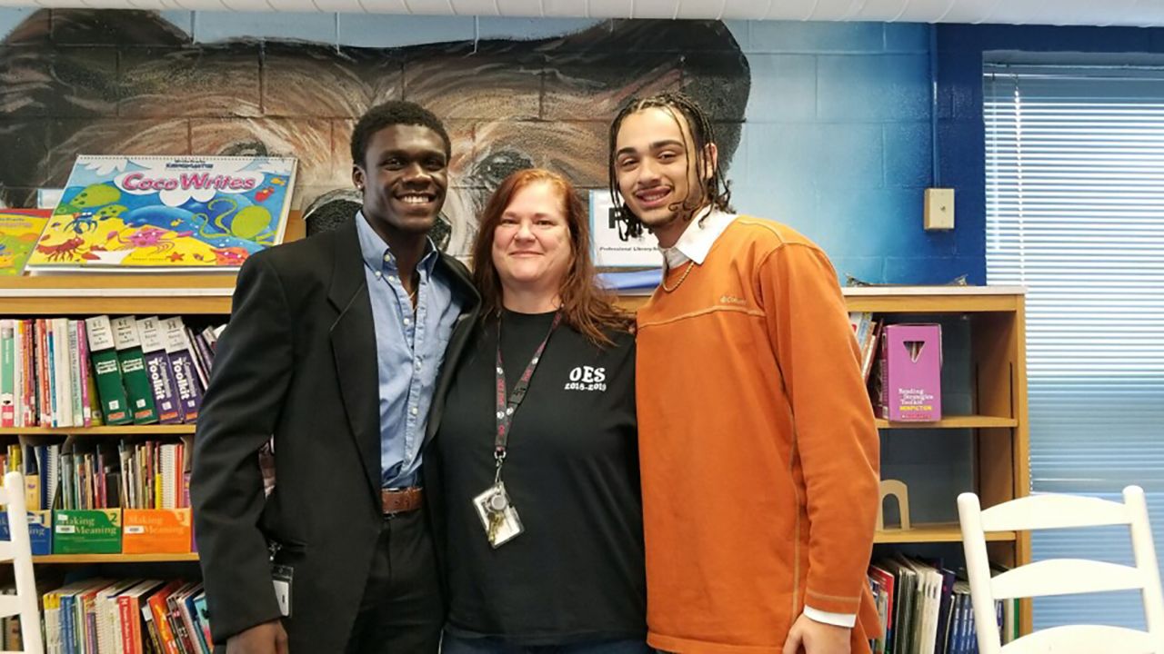 Kyle Fersner (on the right) with his fellow teaching cadet and their former fifth grade teacher.