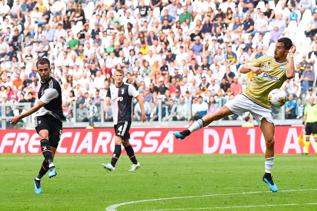 Juventus midfielder Miralem Pjanic (L) shoots to open the scoring during the Serie A clash with Spal.
