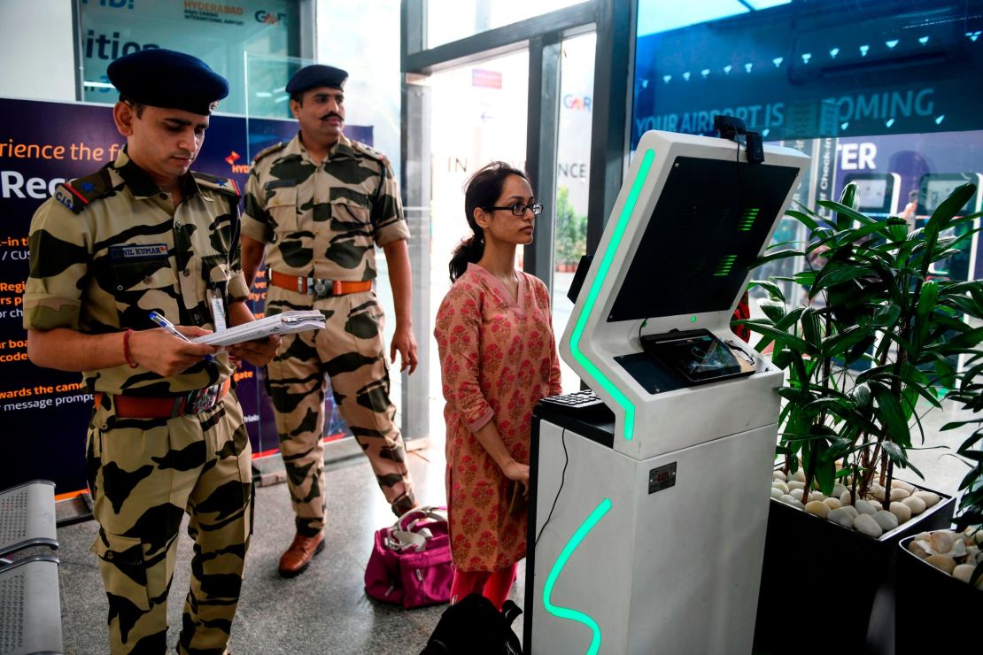 A passenger stands as she registers her personal details at a facial recognition counter at the Rajiv Gandhi International Airport in Hyderabad, on July 26, 2019. 