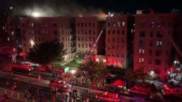 The fire started on a top floor apartment. More than 200 firefighters responded, the New York City Fire Department says.