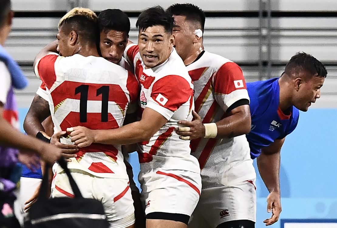Japan's Timothy Lafaele celebrates with teammates after scoring a crucial first half try  during the Rugby World Cup Pool A match against Samoa at the Toyota Stadium.
