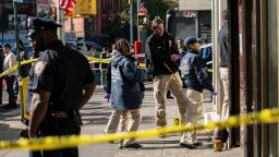 New York Police Department officers investigate the scene of an attack in Manhattan's Chinatown neighborhood, Saturday, Oct. 5, 2019 in New York. Four men who are believed to be homeless were attacked and killed early Saturday in a street rampage. NYPD Detective Annette Shelton said that a fifth man remained in critical condition after also being struck with a long metal object that authorities recovered. (AP Photo/Jeenah Moon)