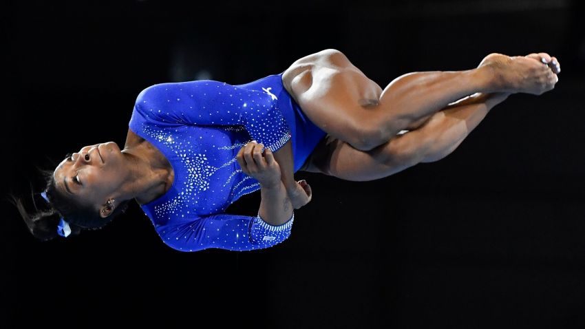 TOPSHOT - US gymnast Simone Biles turns in the air as she performs on the floor during a training session at the FIG Artistic Gymnastics World Championships in Stuttgart, southern Germany, on October 1, 2019. - The world championships will be running from October 4 until October 13, 2019. (Photo by THOMAS KIENZLE / AFP) (Photo by THOMAS KIENZLE/AFP via Getty Images)